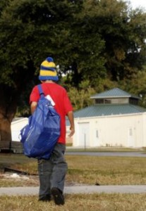 Florida foster boy walking away with My Stuff Bag